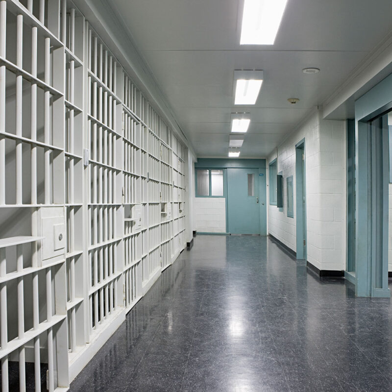 Image inside a prison with jail cells for criminal charges