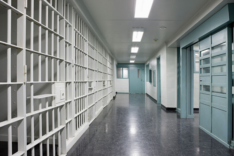 Image inside a prison with jail cells for criminal charges