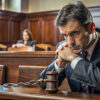 man sitting in courtroom waiting on expungement decision