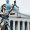 justice is blind photo with scales in front of courthouse