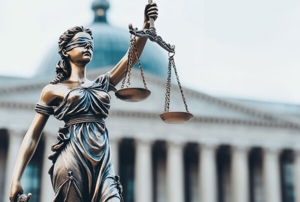 justice is blind photo with scales in front of courthouse