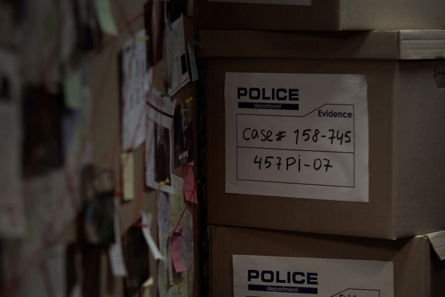 police evidence boxes next to a murder board