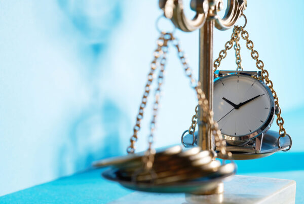 scales of justice with money on one side and clock on the other